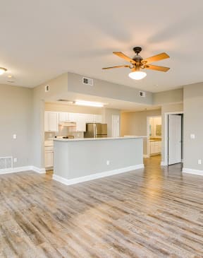 a living room with hardwood floors and a ceiling fan