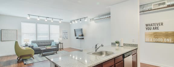 a kitchen with an island and a living room with a couch