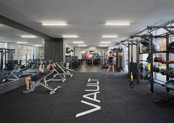 A gym with a black carpet and the word "VAULT" written on it.