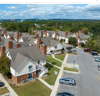 an aerial view of a neighborhood of houses with cars parked