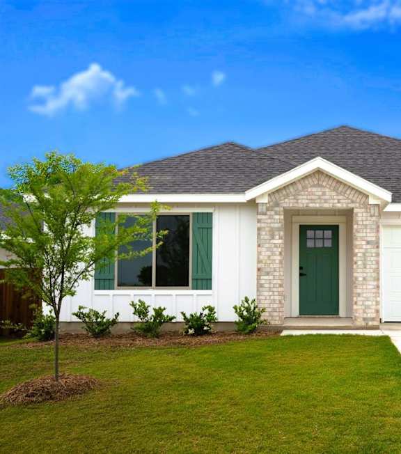 A large swimming pool in front of a house.