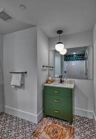A white toilet sits next to a sink in a bathroom.