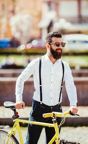 a man standing next to a yellow bike