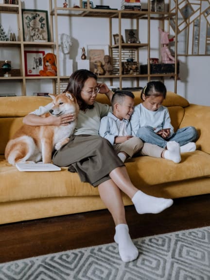 a family sitting on a couch using a tablet computer at 2000 Oasis  Apartments, Atlanta, GA