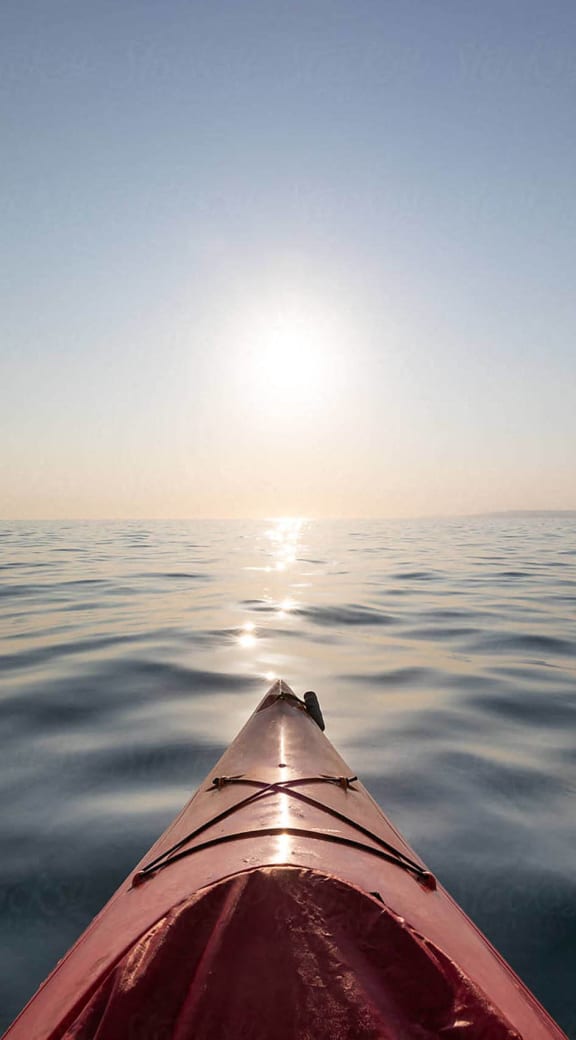 a view of the ocean from the nose of a kayak
