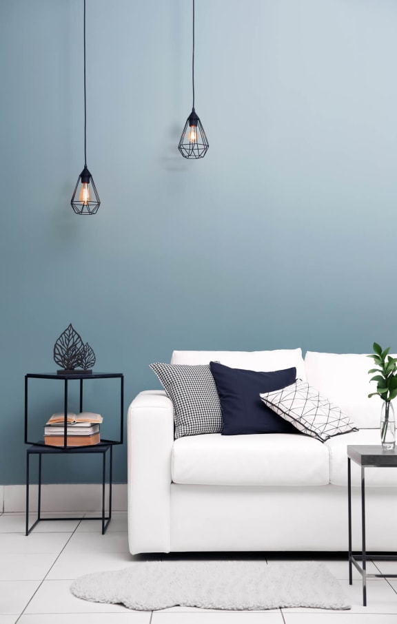 a living room with a white couch and blue walls