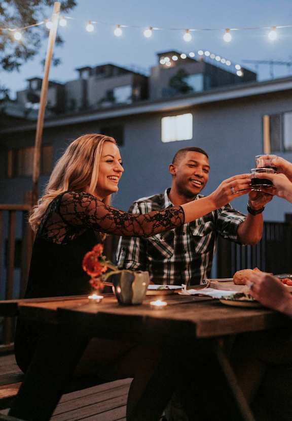 a man and woman sitting at a table with drinks at Shenandoah Station Apartments, Triangle