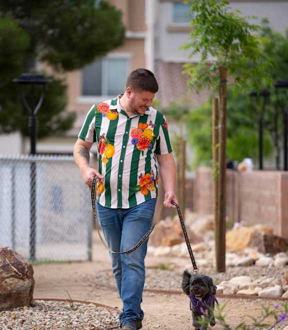A man walking a dog on a leash.