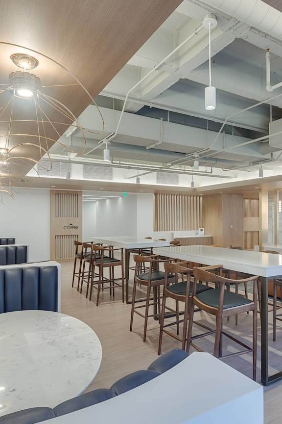 A modern dining area with a bar and chairs.
