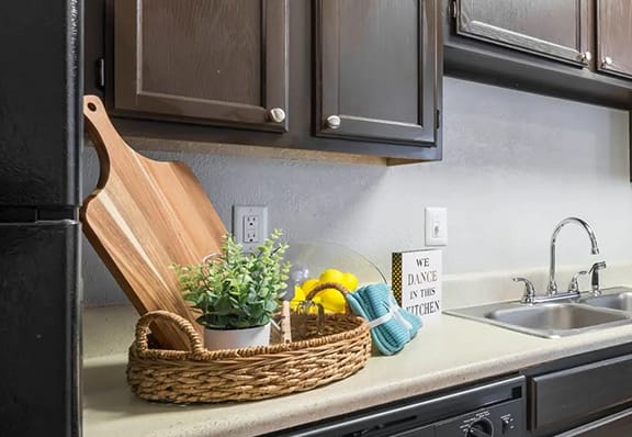 a kitchen with a black stove top oven next to a sink