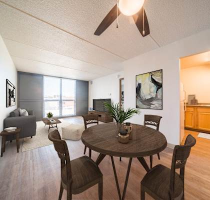 a living room and dining room with a table and chairs at Highpoint Towers Apartments, Erie, PA