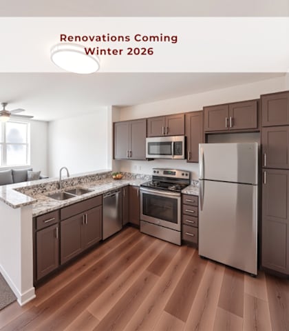 A kitchen with brown cabinets and stainless steel appliances is under renovation.