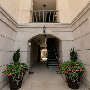 the outside of the building has a staircase and plants at The Villa at River Pointe, Maumelle, AR