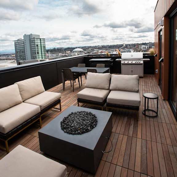 a rooftop deck with couches and a table at Analog Tacoma, Tacoma, Washington
