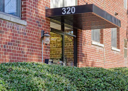 A brick building with the number 320 on it.