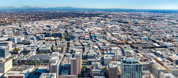 A cityscape with a Bank of America building in the foreground.