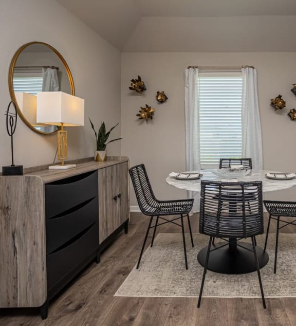 a dining room with a table and chairs next to a door with a window