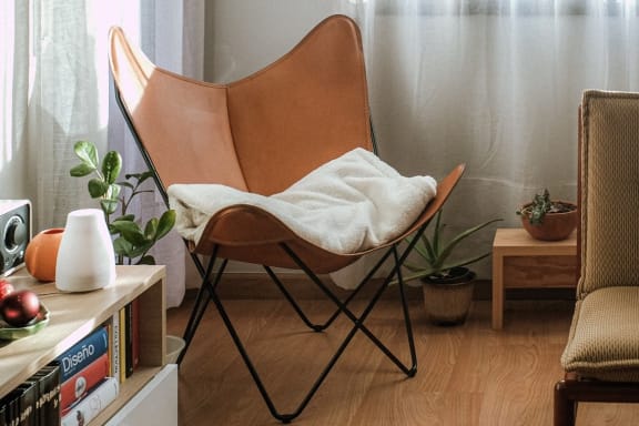 a chair with a blanket on it in a living room