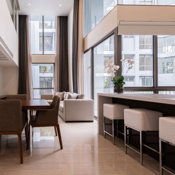 a dining room with a table and chairs in front of a window