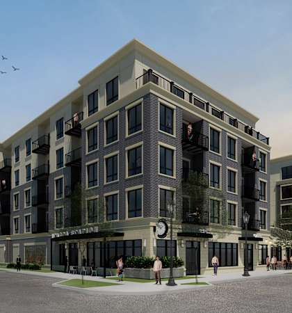 A modern apartment building with a parking lot in front.