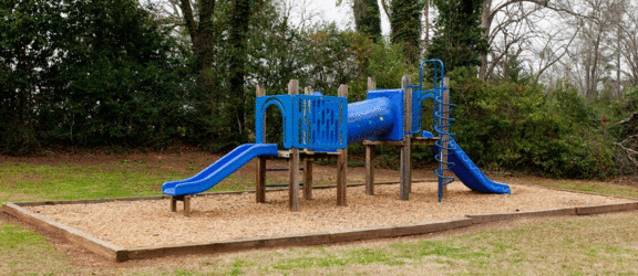 a blue playground in a park