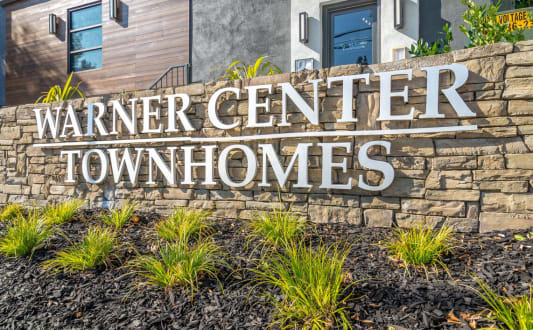 a sign for warner center townhomes in front of a building at Warner Center Townhomes, California, 91303