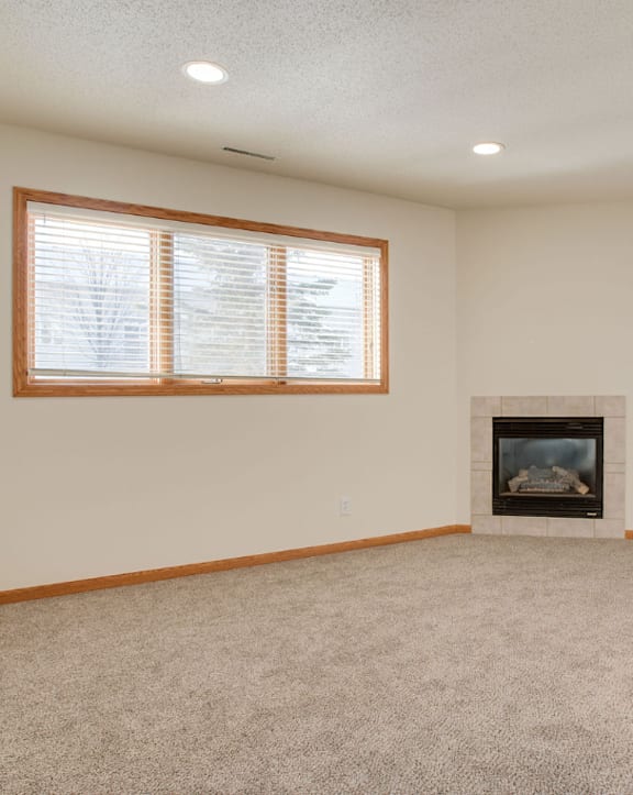 A room with a fireplace and a window.