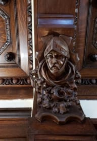 a statue of a man in front of a mirror