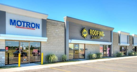 a car dealership with a sign on the front of it