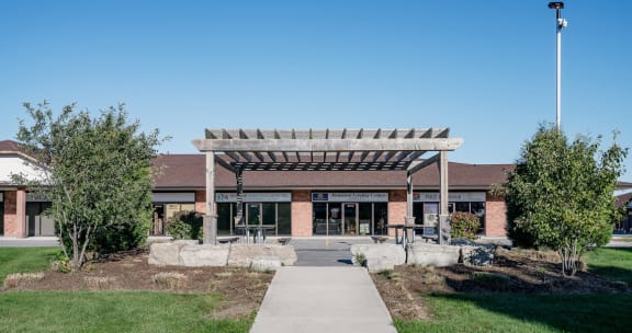 a brick building with a pergola in front of it