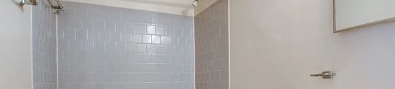 Large bathroom with subway tiled shower