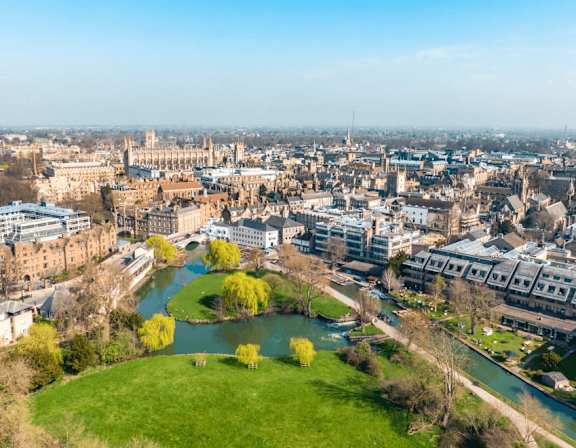 A cityscape with a river running through it. at Origins Apartments, Cambridge