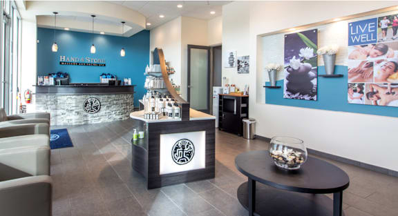 A reception area with a stone counter and a fishbowl on the table. at Palma, Doral, Florida