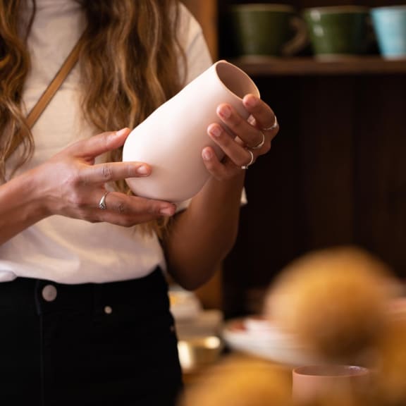 a woman holding a cup in her hands