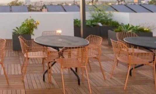 a patio with tables and chairs on a roof