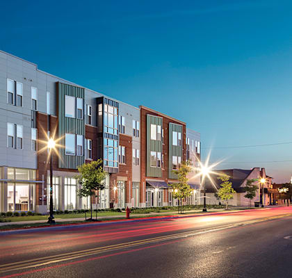 a rendering of a building on a city street at night