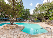 Thumbnail 2 of 13 - Pool surrounded by lounge chairs and seating