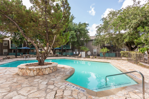 Pool surrounded by lounge chairs and seating