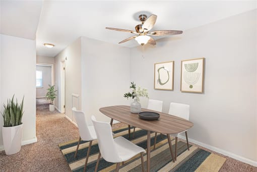 a dining room with a table and chairs and a ceiling fan at Rivers Landing Apartments, PRG Real Estate, Hampton, Virginia