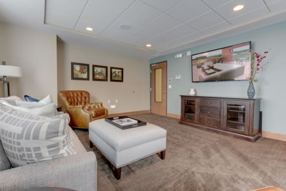 a living room with a couch and a chair at The Legends at Silver Lake Village 55+ Apartments, St. Anthony, 55421