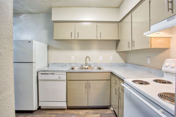 a kitchen with white appliances and white cabinets