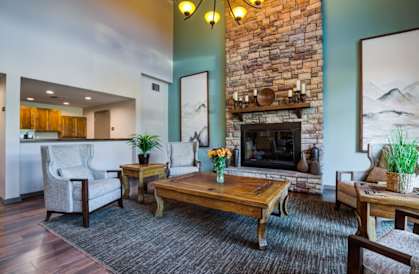 a living room with a fireplace and a table at Creston Point, Seattle, Washington