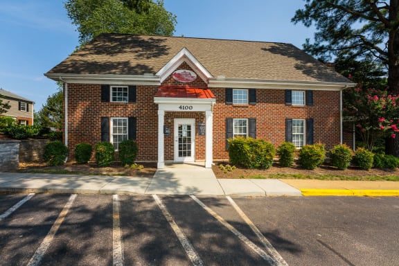 a brick building with a red roof and white trim at Staples Mill Townhomes, Richmond, VA