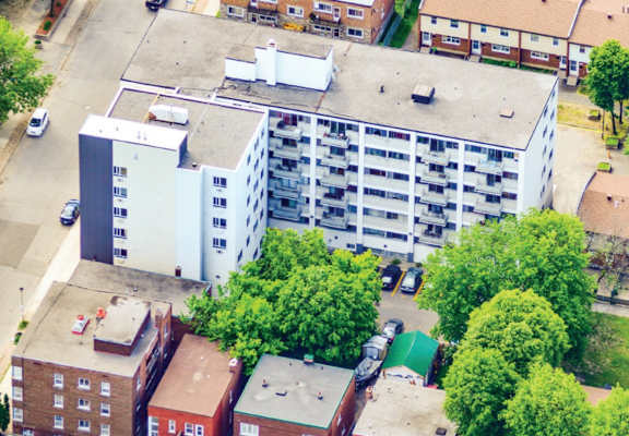 a view from above of a large white building with a gray roof