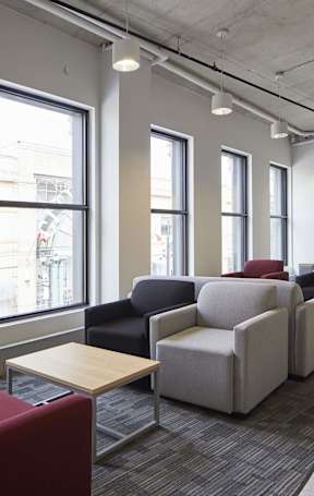 A row of chairs are lined up in a room.