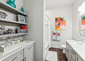 Thumbnail 28 of 31 - A bathroom with a white sink and a white toilet.
