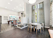 Thumbnail 15 of 31 - A modern dining room with a glass table and chairs.