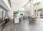 Thumbnail 17 of 31 - A modern kitchen with a dining table and chairs.