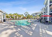 Thumbnail 10 of 31 - A pool area with a small pool and sun loungers.