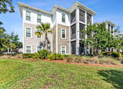 Thumbnail 11 of 31 - A modern two-story house with a balcony on the second floor.